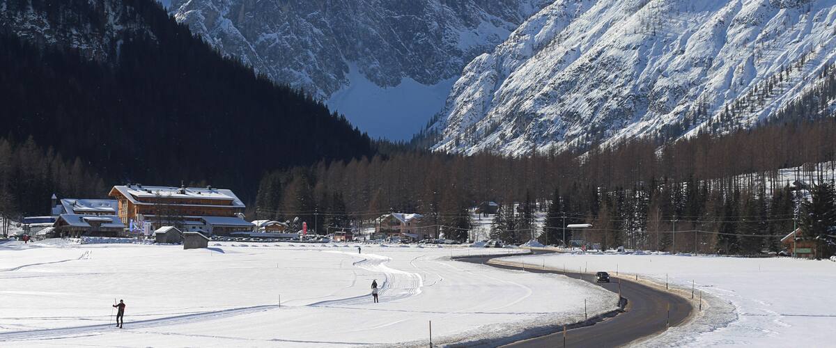 A snow-covered ski resort with mountains in the background.
