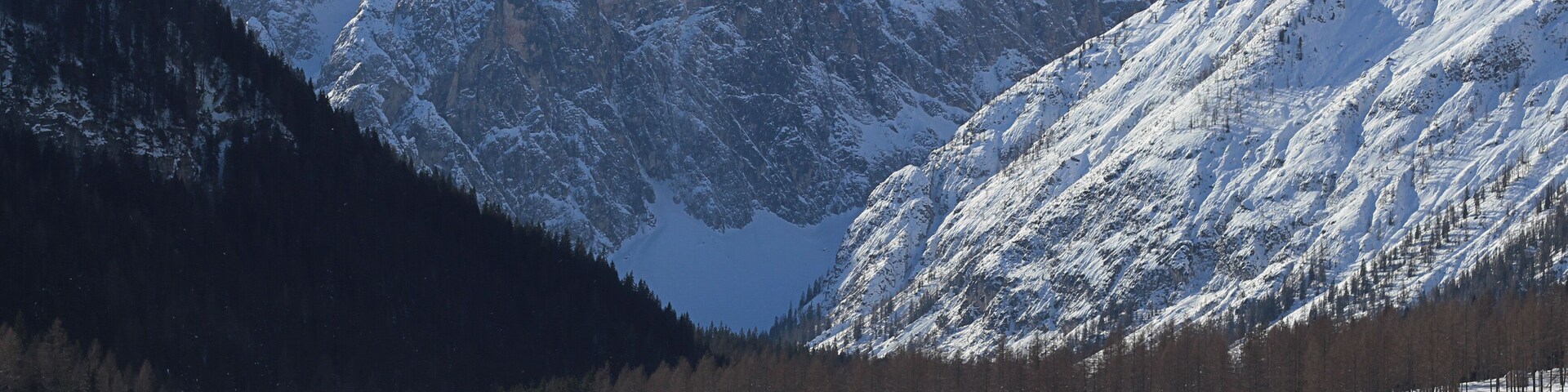 A snow-covered ski resort with mountains in the background.