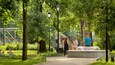 A park with trees, a fountain, and a playground.