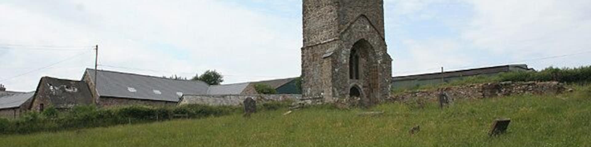 West tower of the former parish church of St James, Upton, somerset, seen from the southeast. The nave and chancel were to the right, but their walls have been reduced to a height of about half a metre.