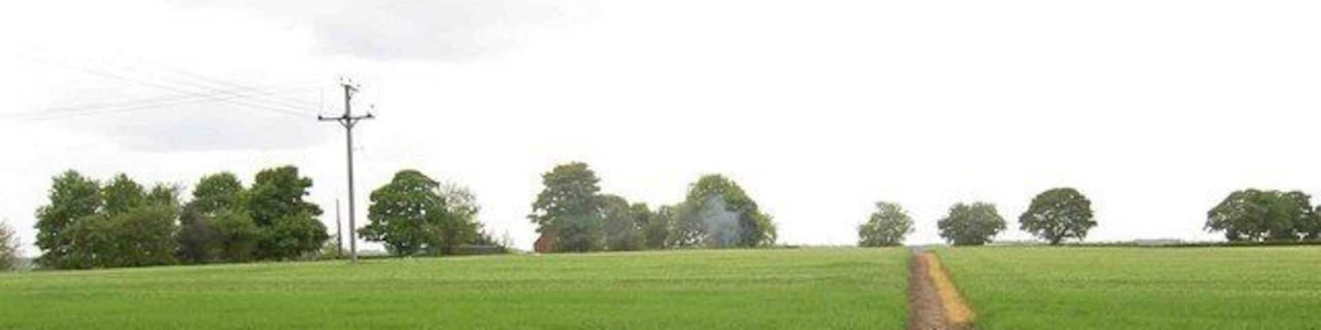 Smoke up at Elmsall Lodge Farm The bridleway turns into a metalled surface behind the photographer.