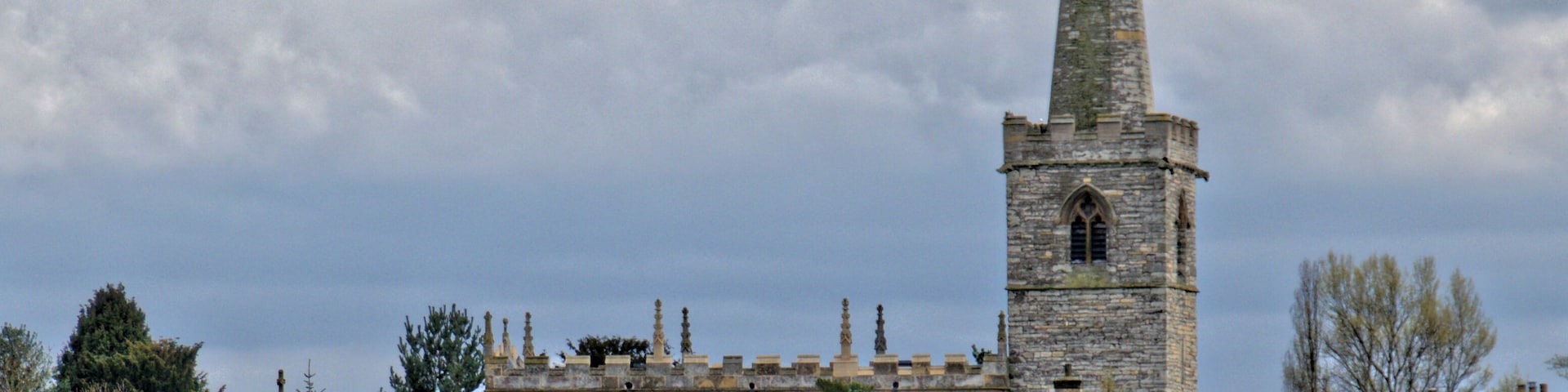 The body of the church dates from the 13th century, in Early English style, including aisles and the lower part of the tower. The spire and chancel date from the 14th century, the latter being rebuilt in 1840. The clerestory is a 16th century addition, and the nave roof is of this date, although restored in 1768. There was further extensive restoration in 1880.