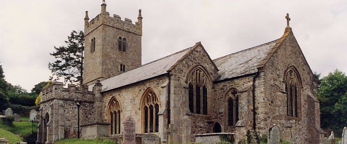 An old stone church with a tower and arched windows.