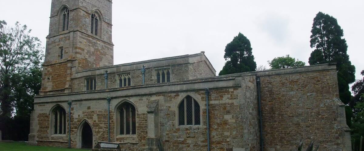A historic church with a tall tower and arched windows.