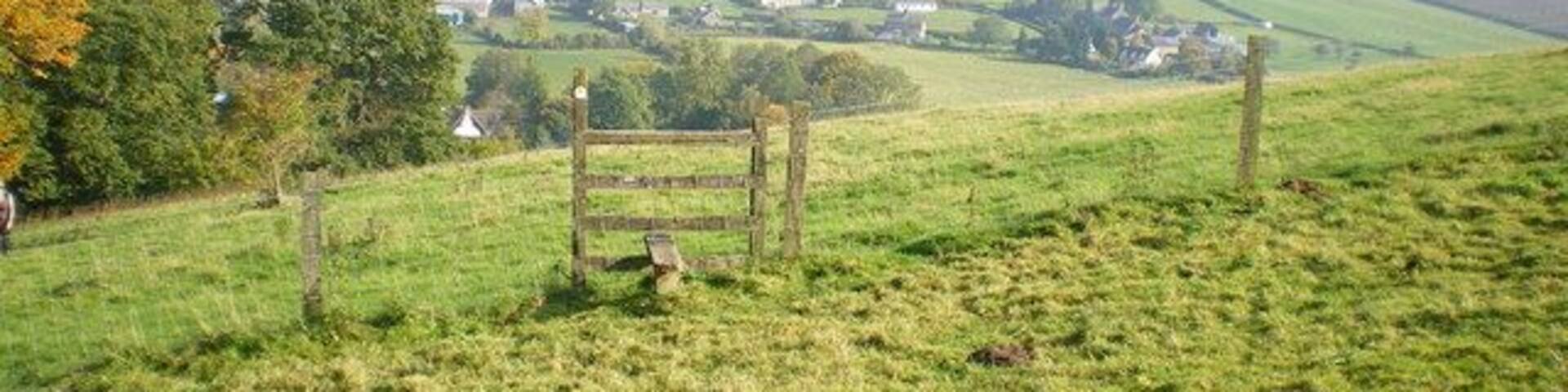 Kempton and Burrow hillfort from Clunton Hill Eastwards from the footpath up Clunton Hill, over the Kemp valley, to the hillfort on Burrow. It was a particularly hazy day.