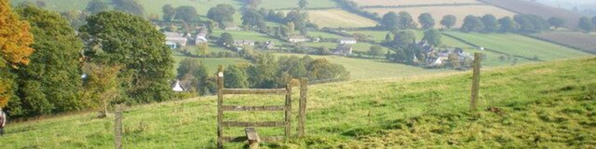 Kempton and Burrow hillfort from Clunton Hill Eastwards from the footpath up Clunton Hill, over the Kemp valley, to the hillfort on Burrow. It was a particularly hazy day.