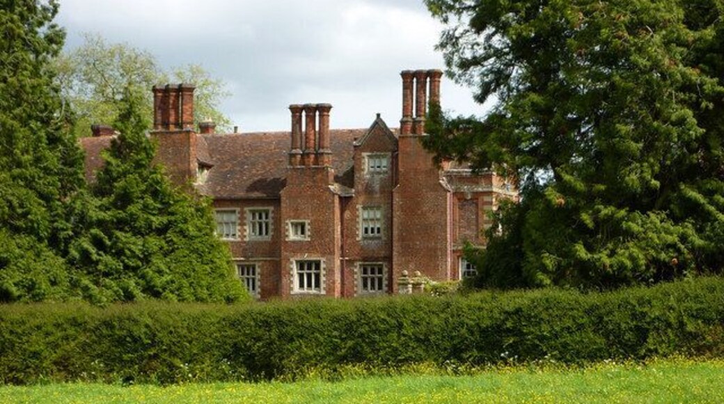 Glimpse of Playford Hall Seen from the track through the meadow to the west, which is lined by electric fences.