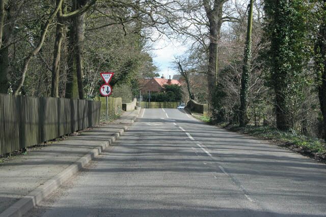 Smite Bridge, Colston Bassett A narrow bridge over the River Smite with traffic priority signs. The private grounds to Colston Bassett Hall are to the left.