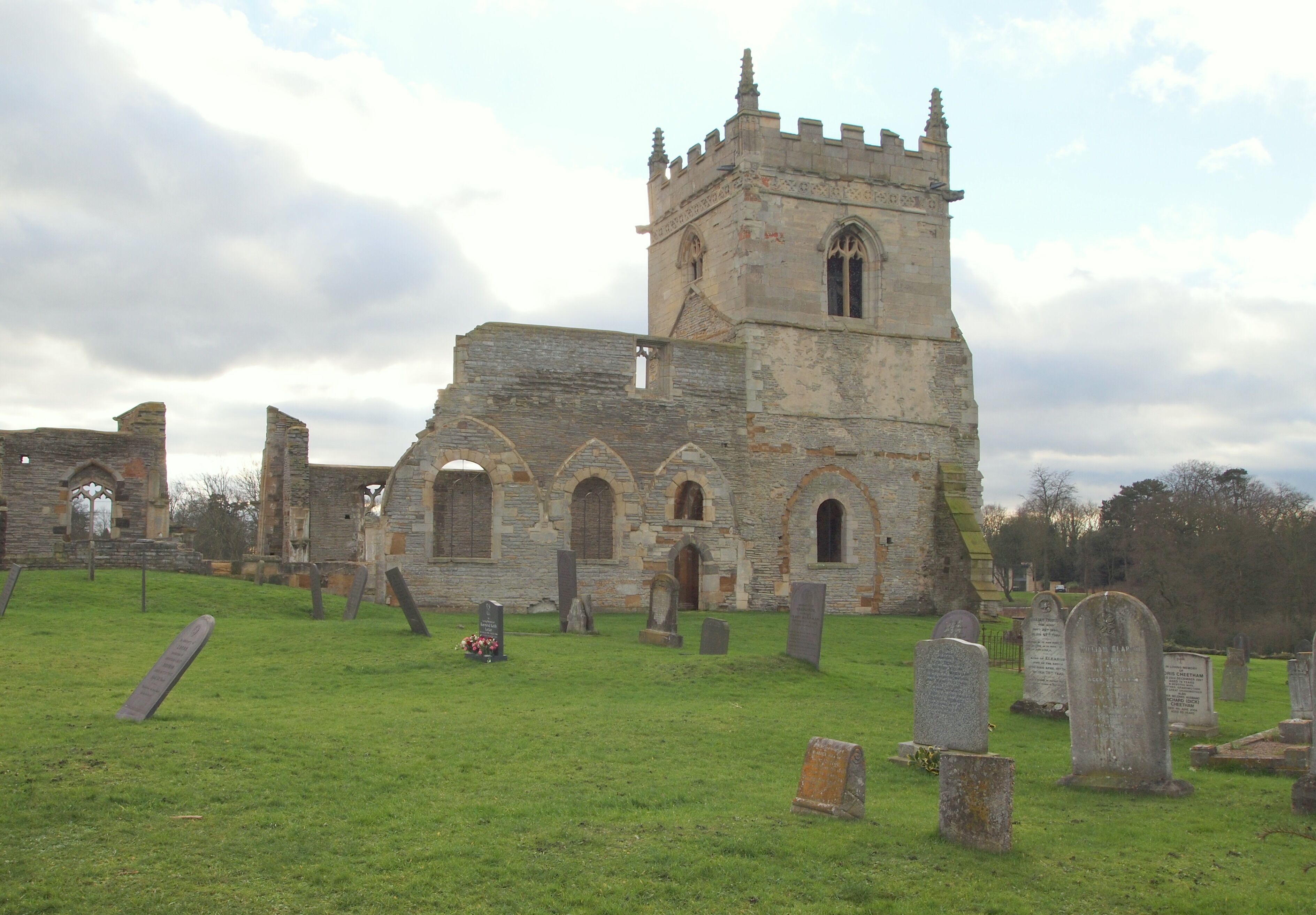 An old stone church with a tower and arched windows.