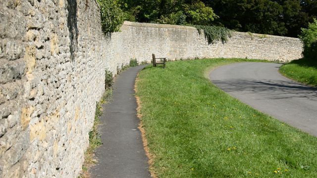Church Lane. The photograph is looking easterly along Church Lane. The wall forms the boundary with Brompton Hall School. Ahead the lane leads toward 426956. Behind the viewpoint is the lanes junction with West Brow. For a more easterly (ahead) photograph of the lane, click here 426845. For a more westerly (behind) photograph of the lane, click here 427677.