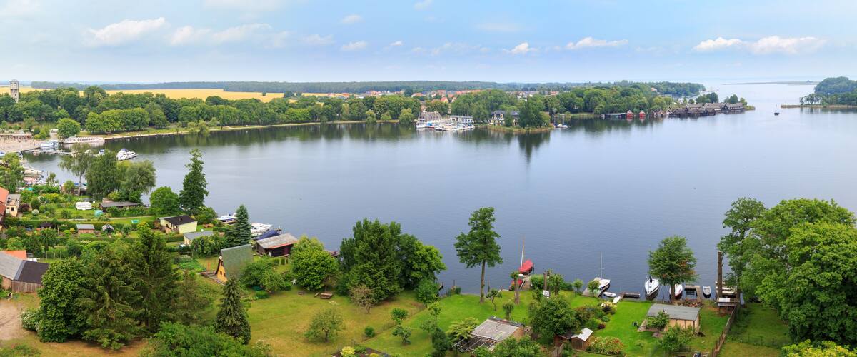 A lake surrounded by trees and houses.