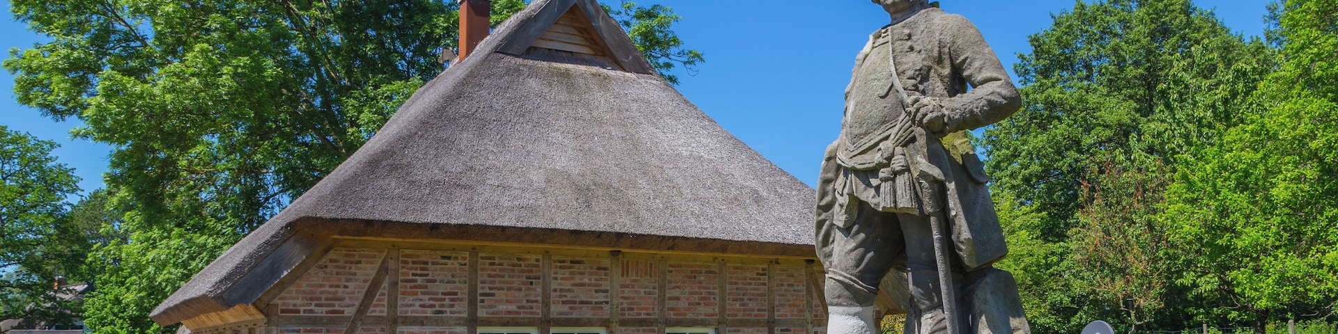 The Traitor's House (Verräterhaus) in Groß Stresow, district of Putbus, Landkreis Vorpommern-Rügen, Mecklenburg-Vorpommern, Germany. On the right side the statue of Friedrich Wilhelm I of Prussia.