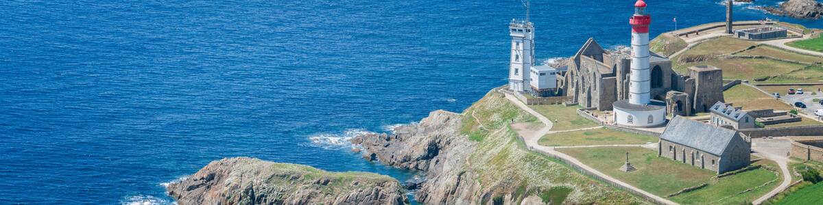 Aerial view of Saint-Mathieu Lighthouse located in Plougonvelin, around Brest in Finistère, and close the ruins of the ancient Abbaye Saint-Mathieu de Fine-Terre. France