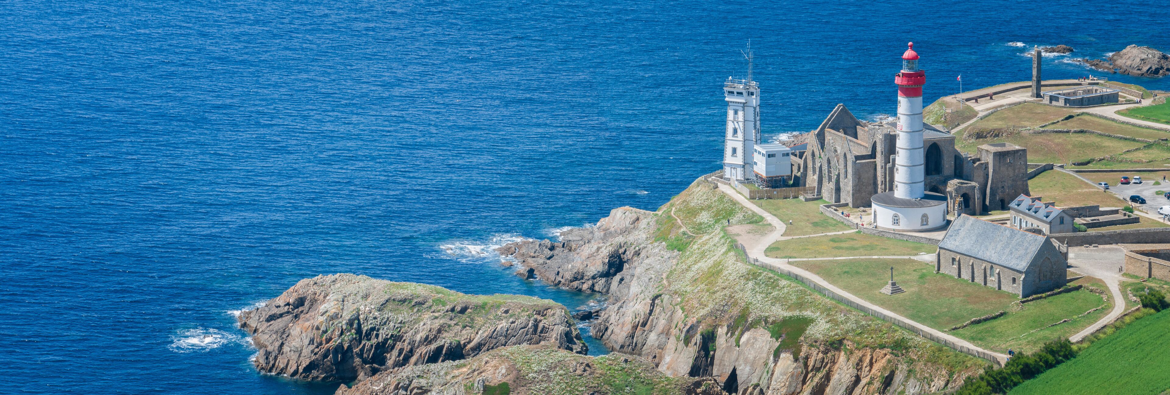 A coastal lighthouse and fortification with a rugged coastline.