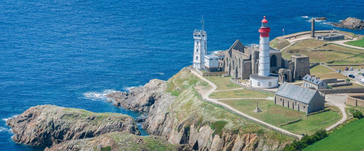 A coastal lighthouse and fortification with a rugged coastline.