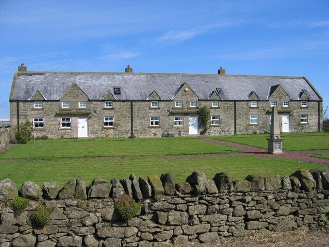 Bradshawgate Cottages, Swinhoe. Obelisk commemorates the restoration, in 1992, of this previous derelict terrace of cottages.