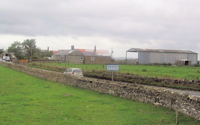 A rural landscape with a stone wall, a car, and a building labeled 'SWINHOE'.
