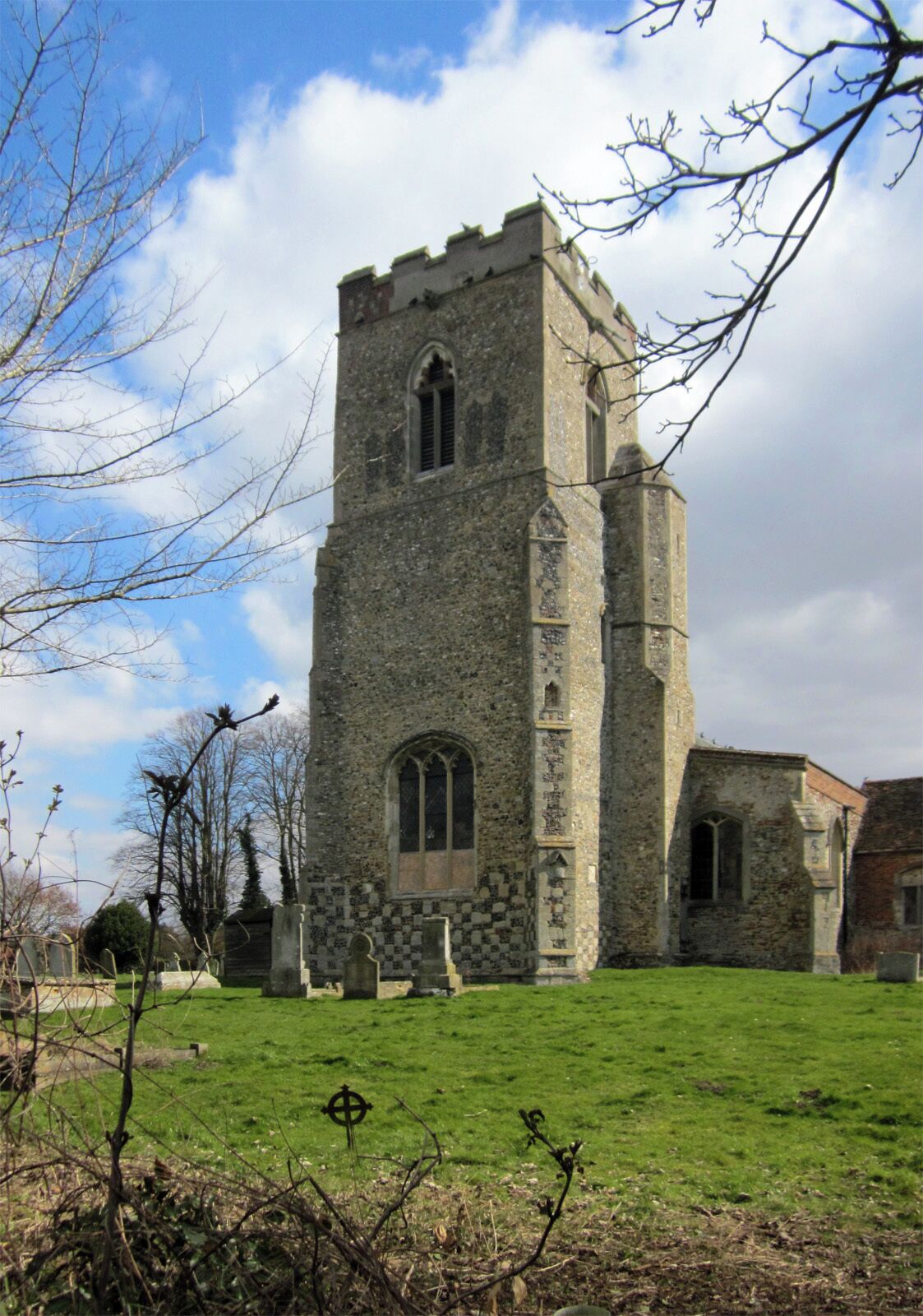 A stone church with a tall tower and arched windows.
