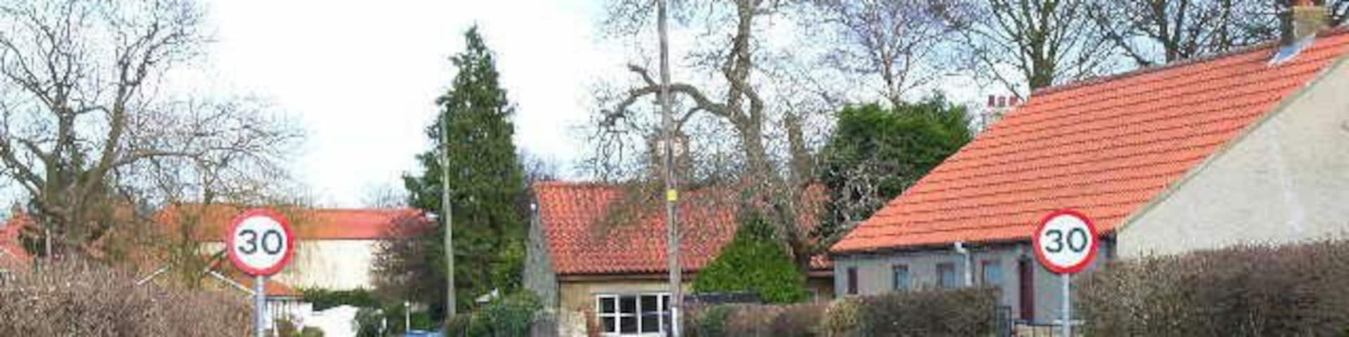 Scorton - the old road to Catterick. The 1940s map clearly shows that the B6271 left Scorton by the north-west corner of the green. This has now been replaced by a new road leaving the village to the south-west, leaving the pictured road as a cul-de-sac. Looking east.