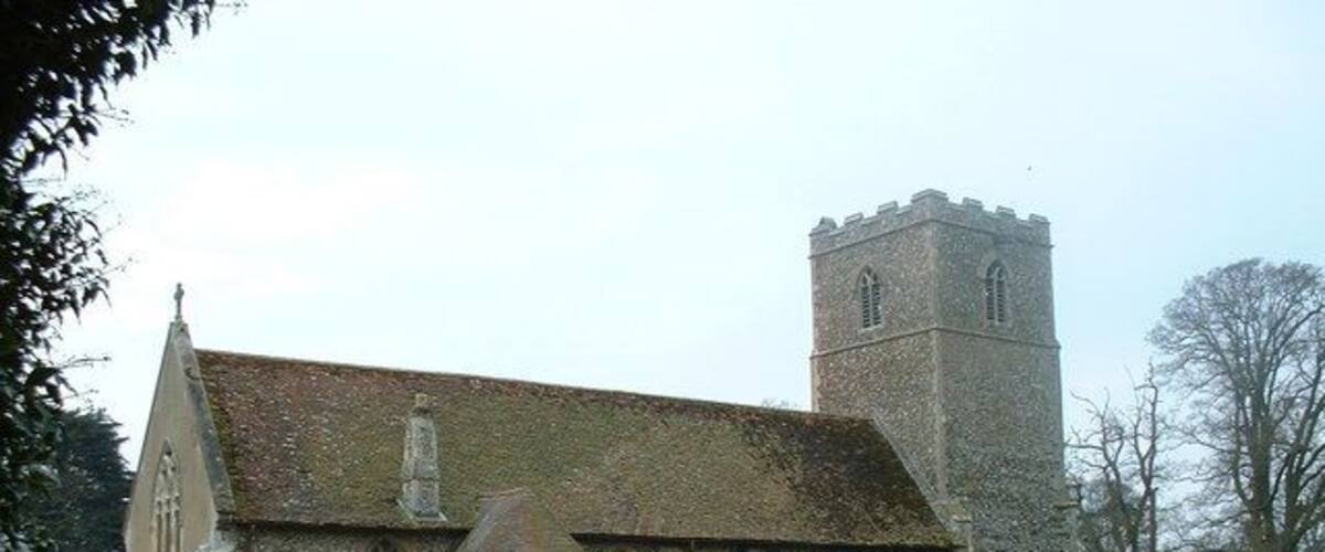 A church with a tower and a graveyard.