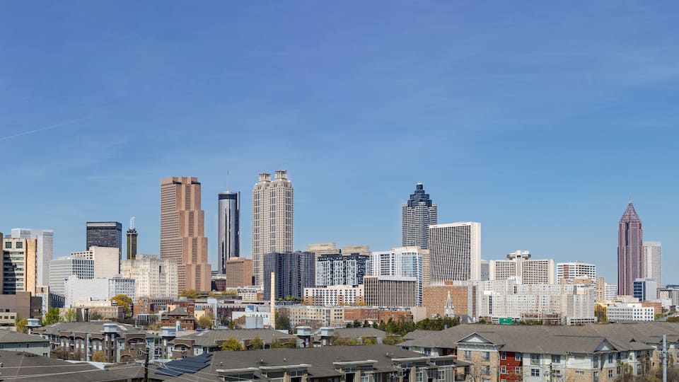 Downtown Atlanta Skyline showing several prominent buildings hotels under a blue sky.