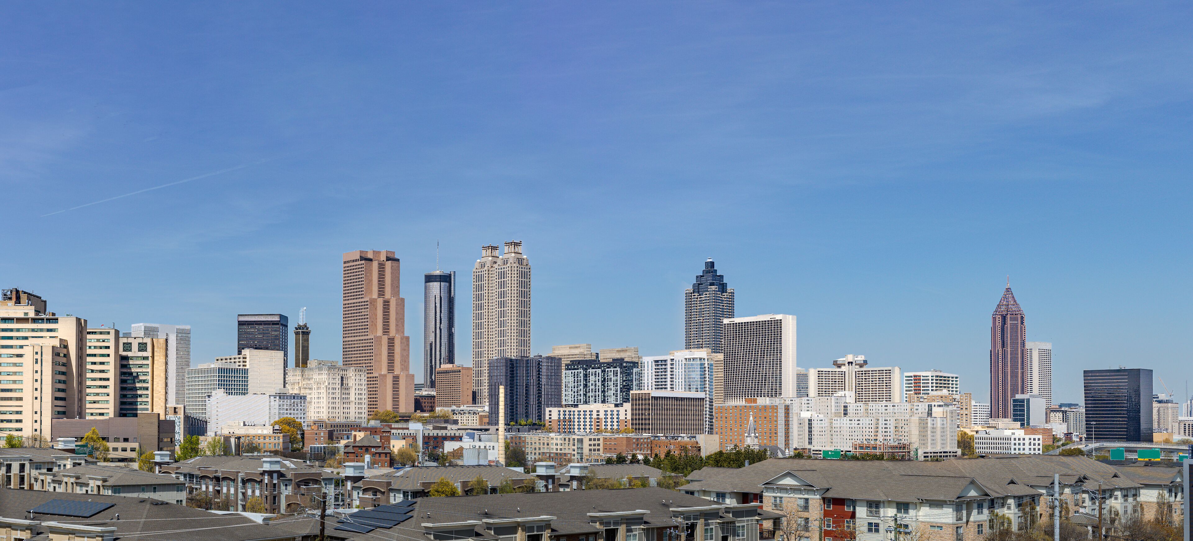 A city skyline with various high-rise buildings and residential areas.
