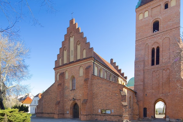 A historic church with a prominent tower and a steeply pitched roof.