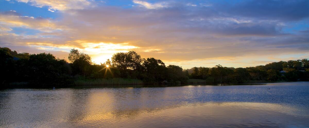 Terrigal Lagoon which includes a sunset and a lake or waterhole