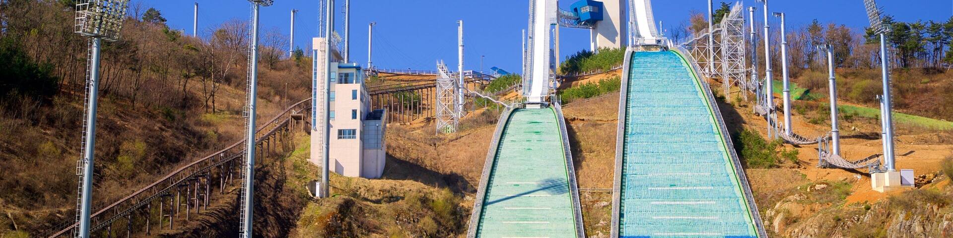 A ski lift with a chairlift and a gondola lift, surrounded by a mountainous landscape.