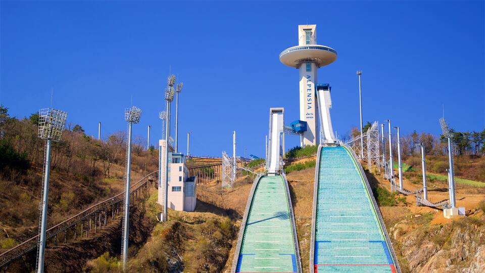 A ski lift with a chairlift and a gondola lift, surrounded by a mountainous landscape.