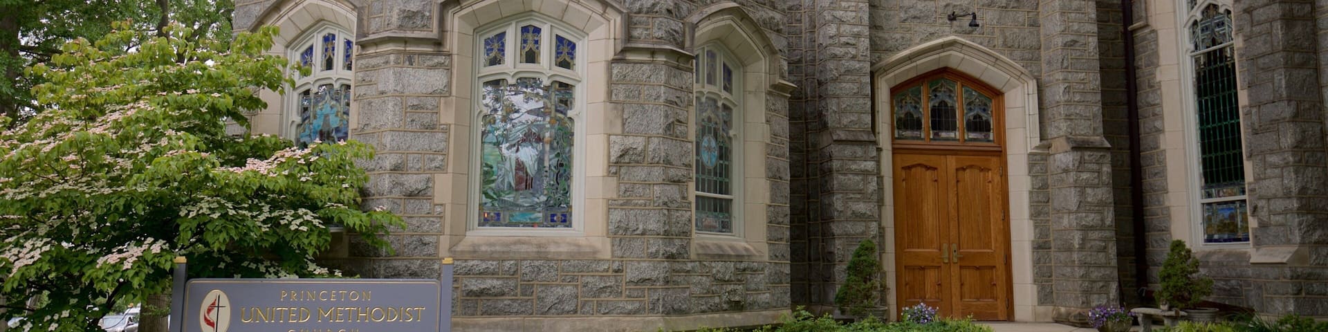 Princeton United Methodist Church with a stone facade, stained glass windows, and a sign indicating Sunday services.