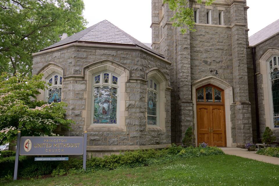 Iglesia Metodista Unida de Princeton, con fachada de piedra, vidrieras de colores y un cartel que anuncia los servicios dominicales.