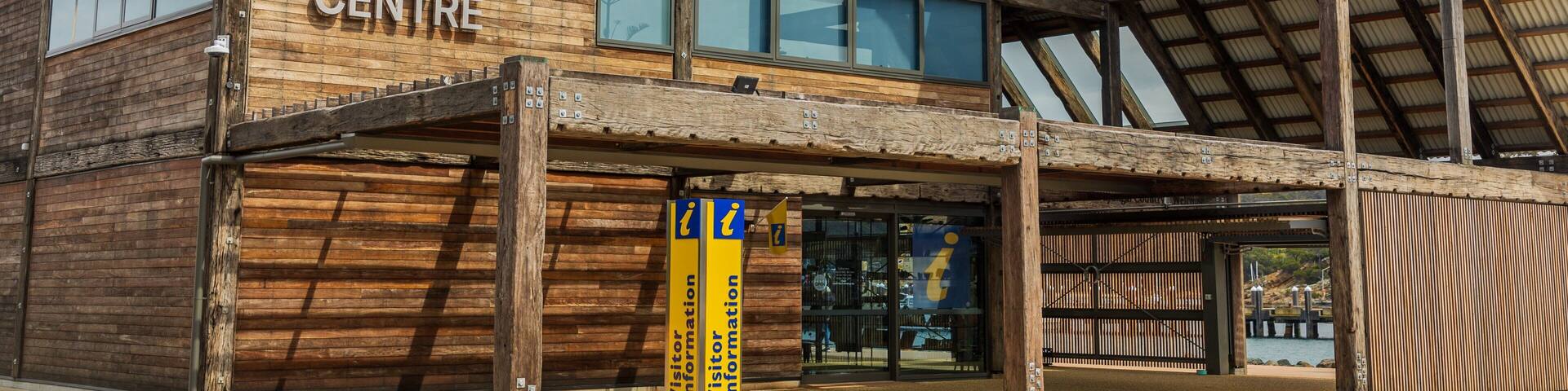 A wooden building with the sign 'Port Authority of New South Wales Eden Welcome Centre'.