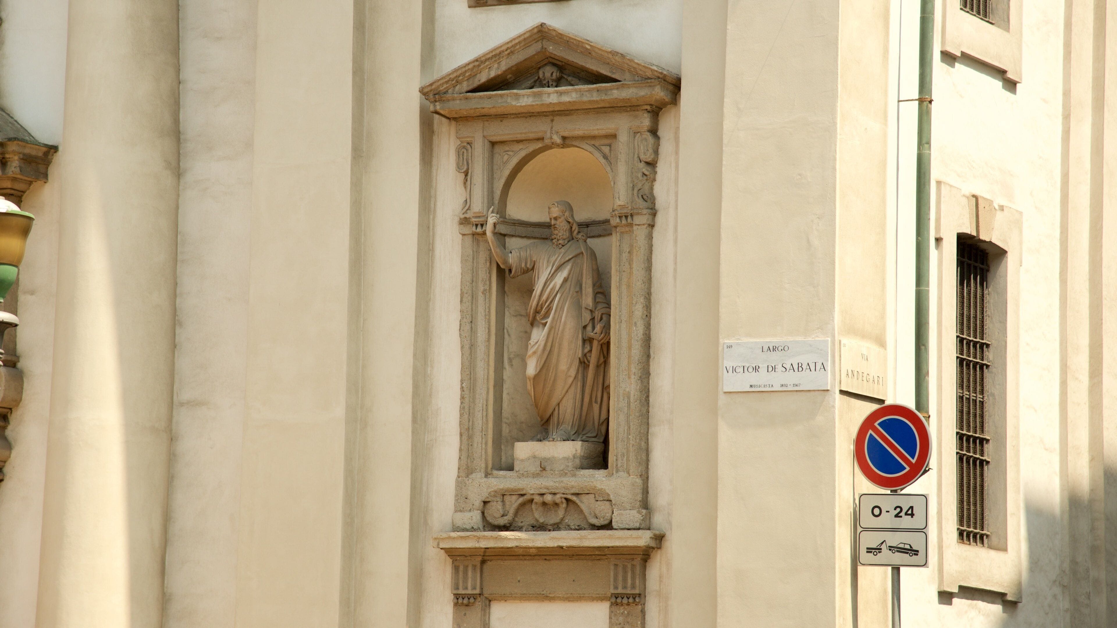 Milan featuring a statue or sculpture, a church or cathedral and signage