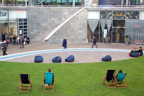Paddington showing a square or plaza as well as a small group of people