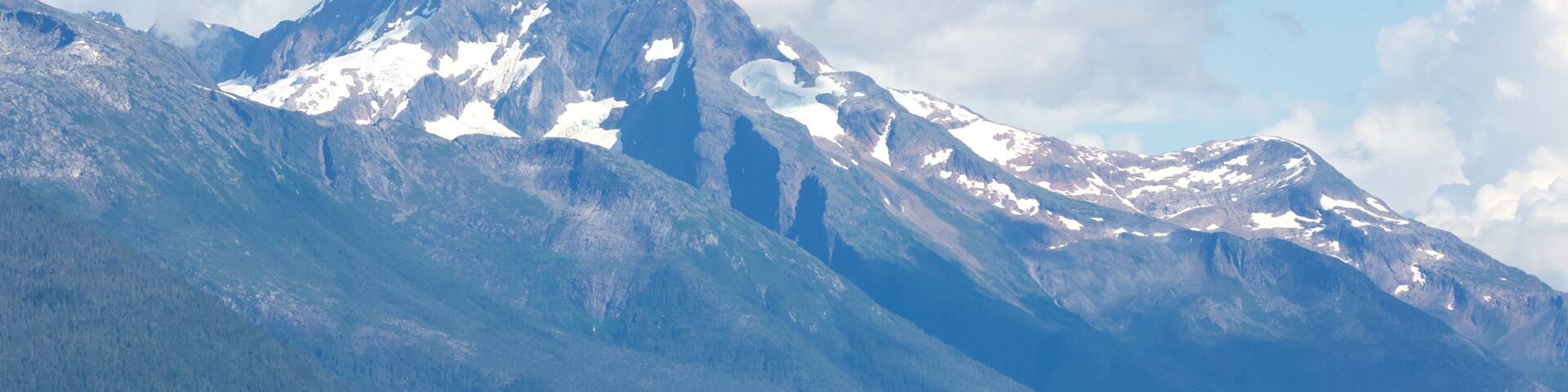 Tracy Arm featuring a lake or waterhole and mountains