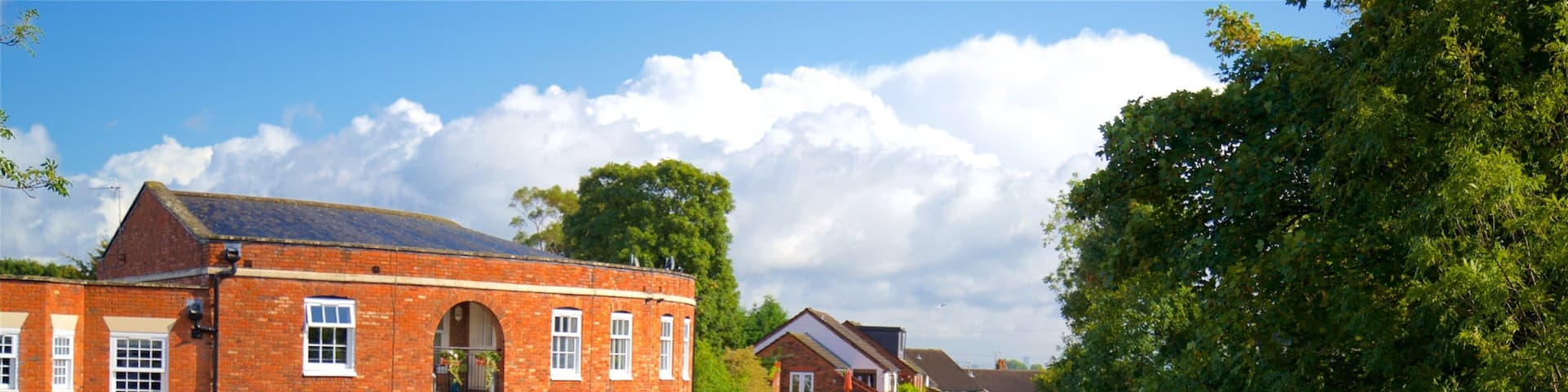 Lymm showing boating, a river or creek and a small town or village