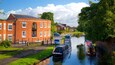 Lymm showing boating, a river or creek and a small town or village