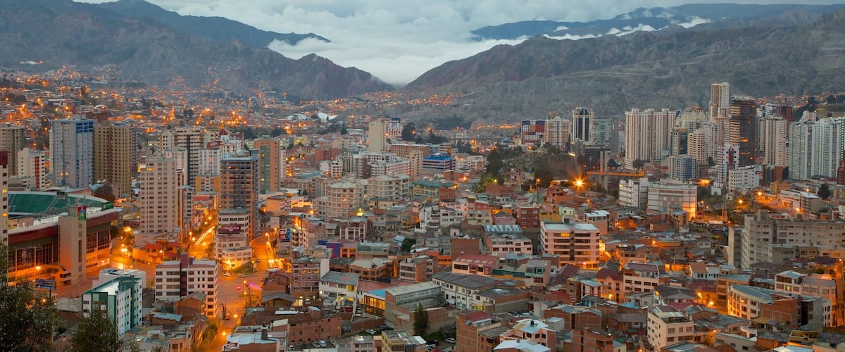 A cityscape with a mountainous backdrop.
