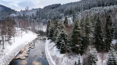 Beautiful snowy winter forest landscape, Tepla River under Brezova dam, Karlovy Vary, Czech Republic