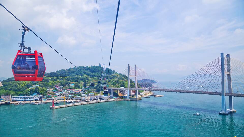 A cable car system, a bridge, and a coastal town.