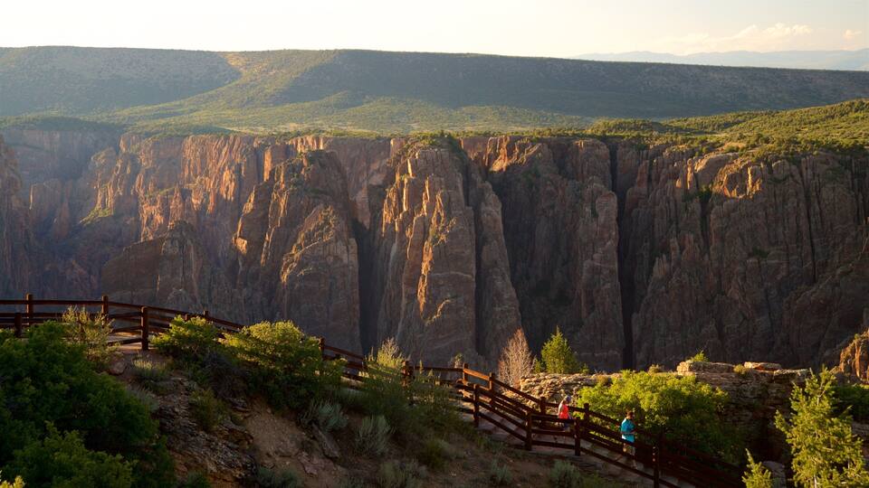 A canyon with steep cliffs and a wooden walkway.