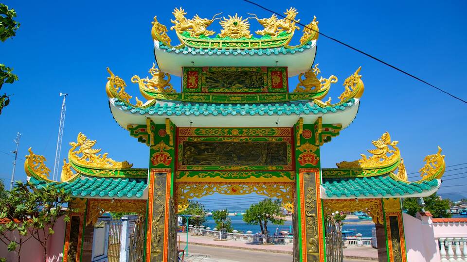 A traditional Chinese gate with ornate golden dragons and green and white colors.