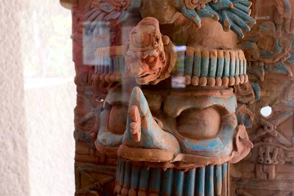 A detailed stone carving with intricate patterns and a prominent central figure.
