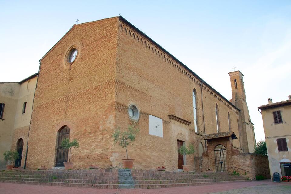 A historic church with a bell tower, arched windows, and a brick facade.
