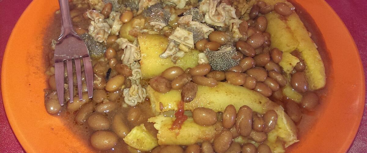 A plate of food with rice, beans, potatoes, and broccoli.