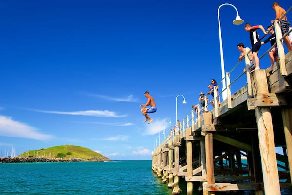 Coffs Harbour which includes a bay or harbour and swimming as well as a small group of people