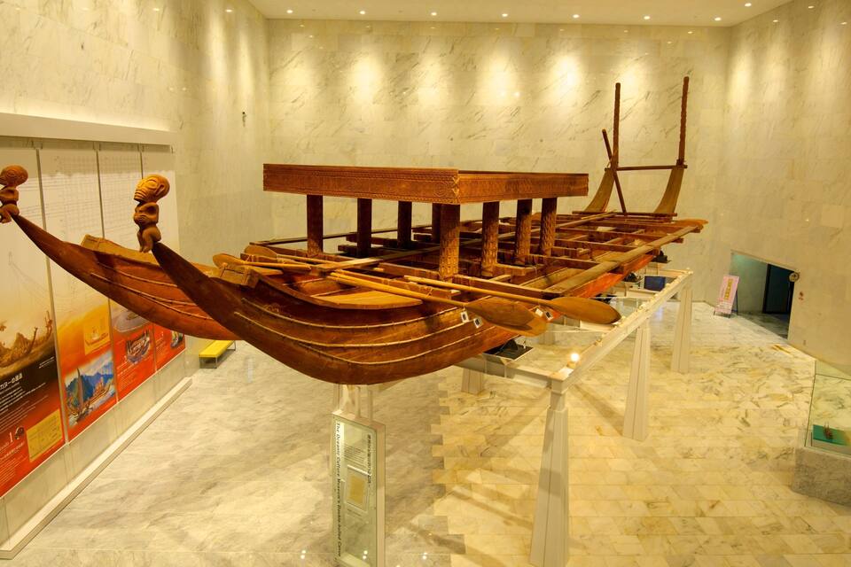 A museum exhibit featuring a traditional double-hulled canoe.