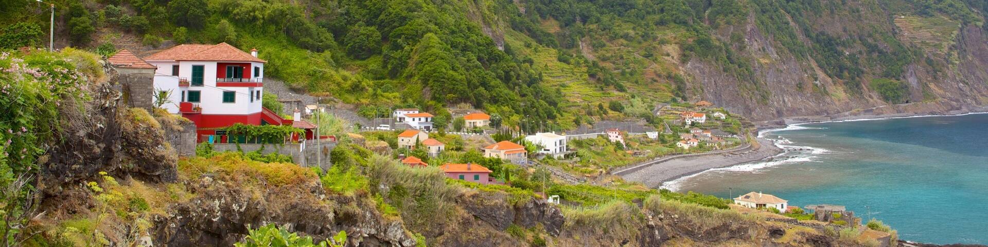A coastal village with houses on a hillside overlooking the sea.
