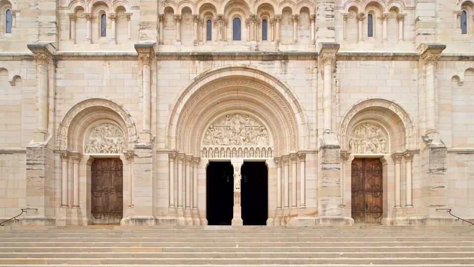 A grand cathedral with intricate stone carvings, large wooden doors, and a symmetrical facade.